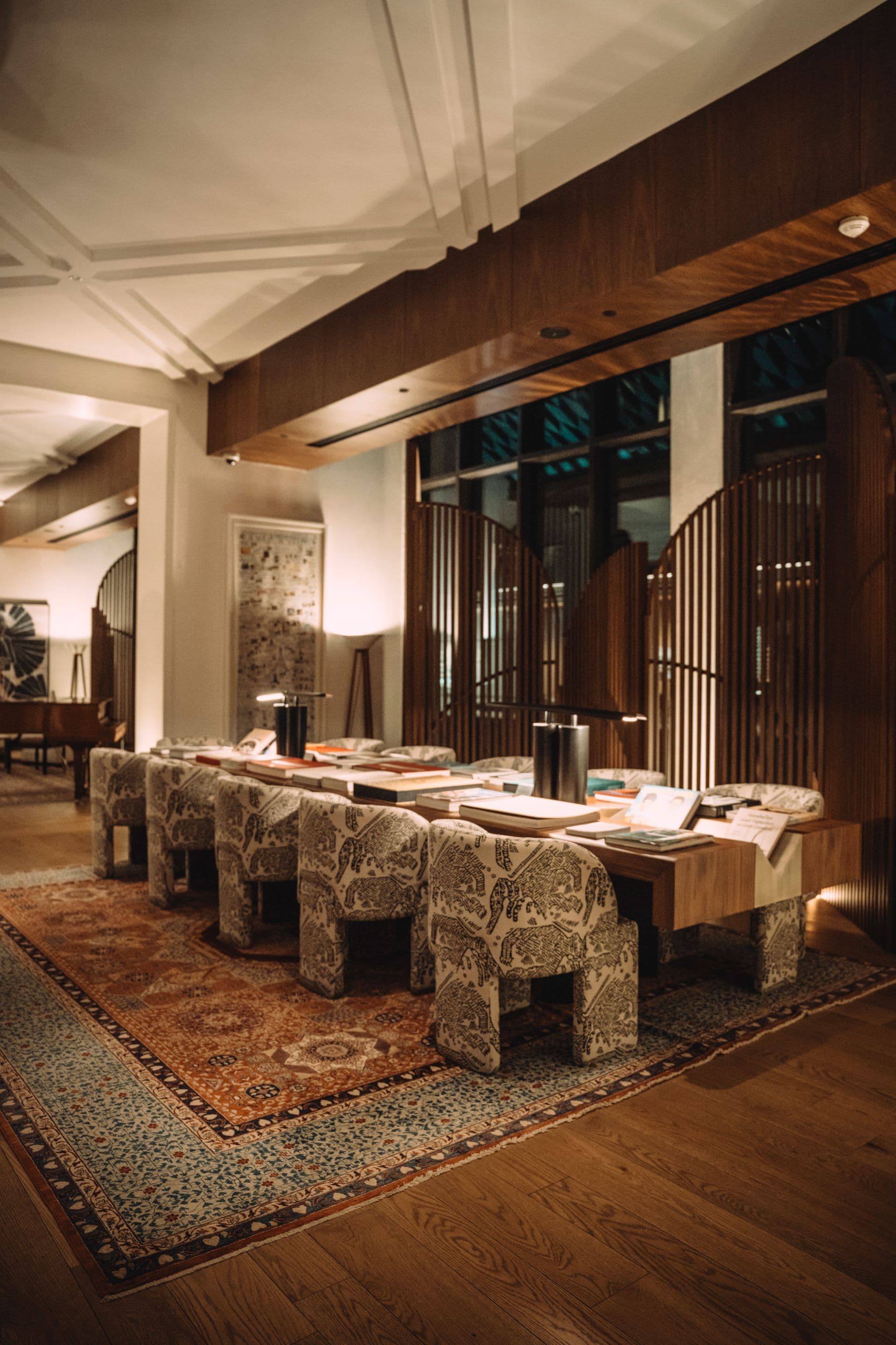 A warm, wood-paneled lounge with library seating